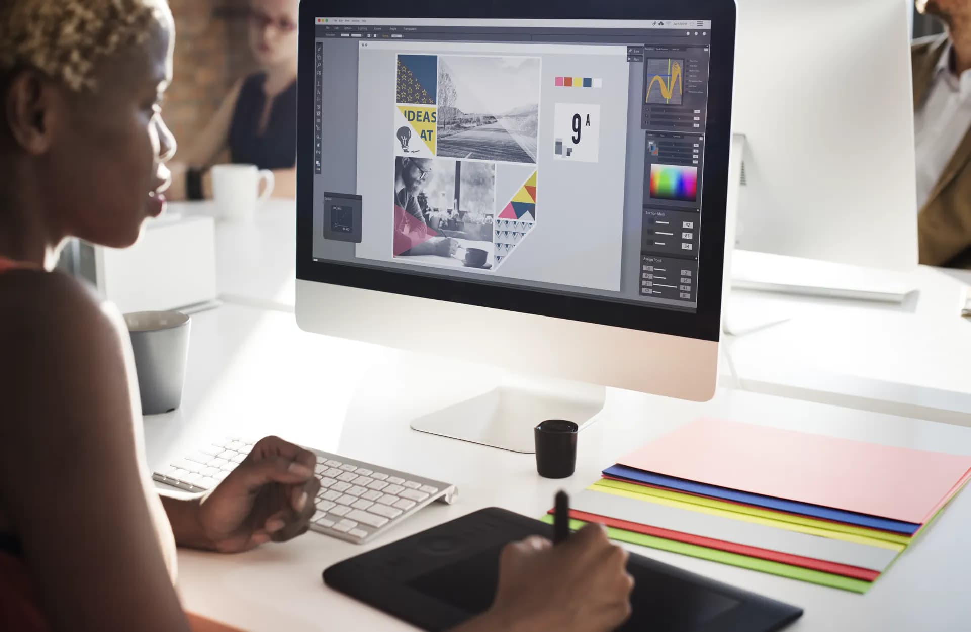 Brand designer creating visual identity concepts at a professional workstation