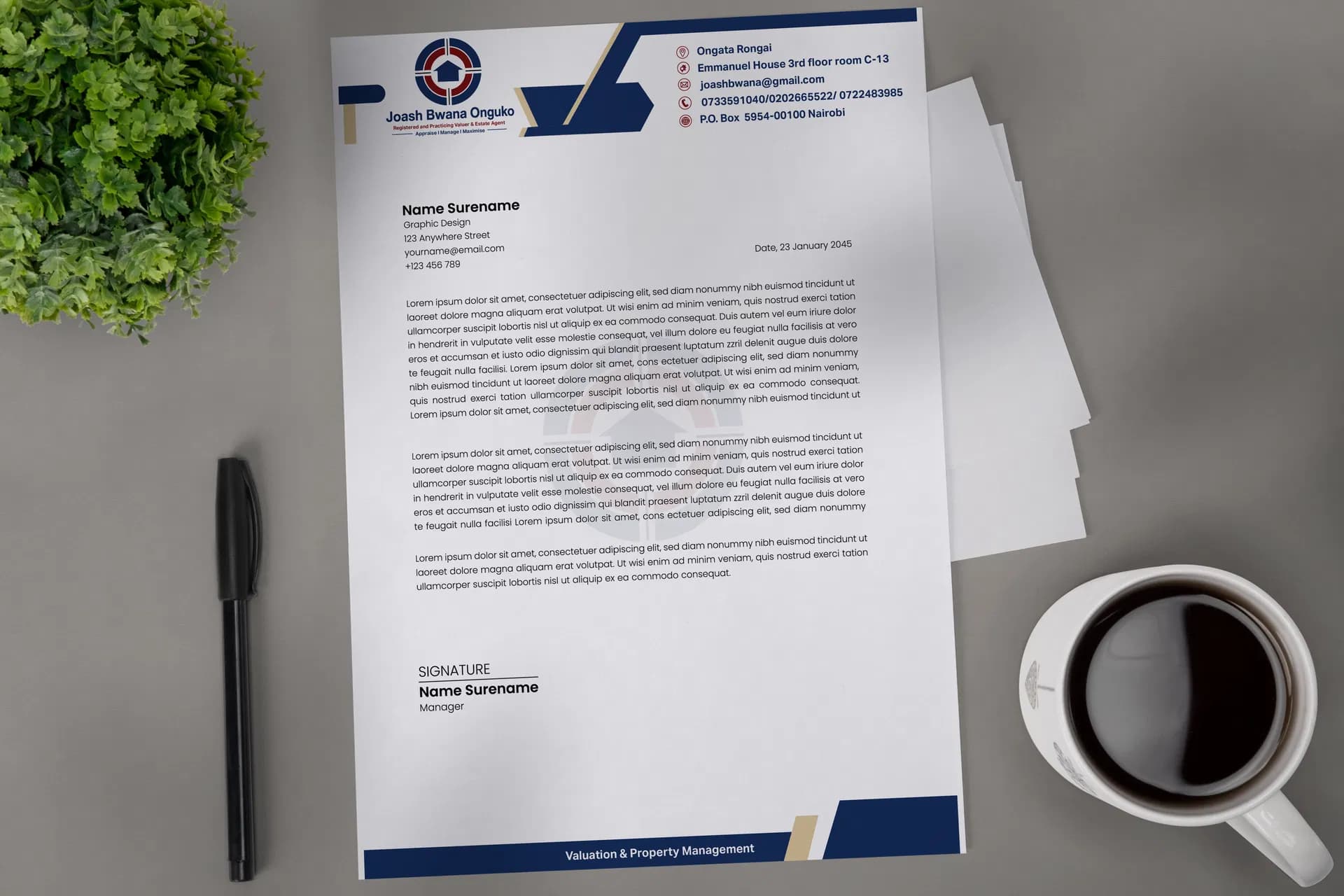 Navy corporate letterhead on a desk with a pen and coffee