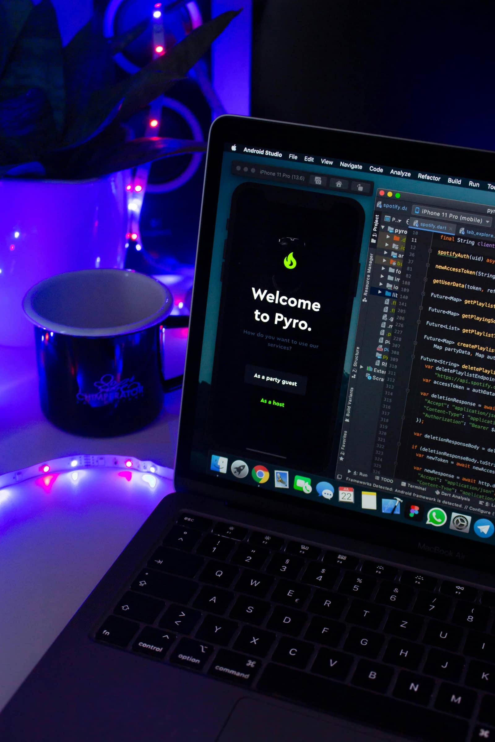 Android Studio open beside an iPhone simulator during mobile app development