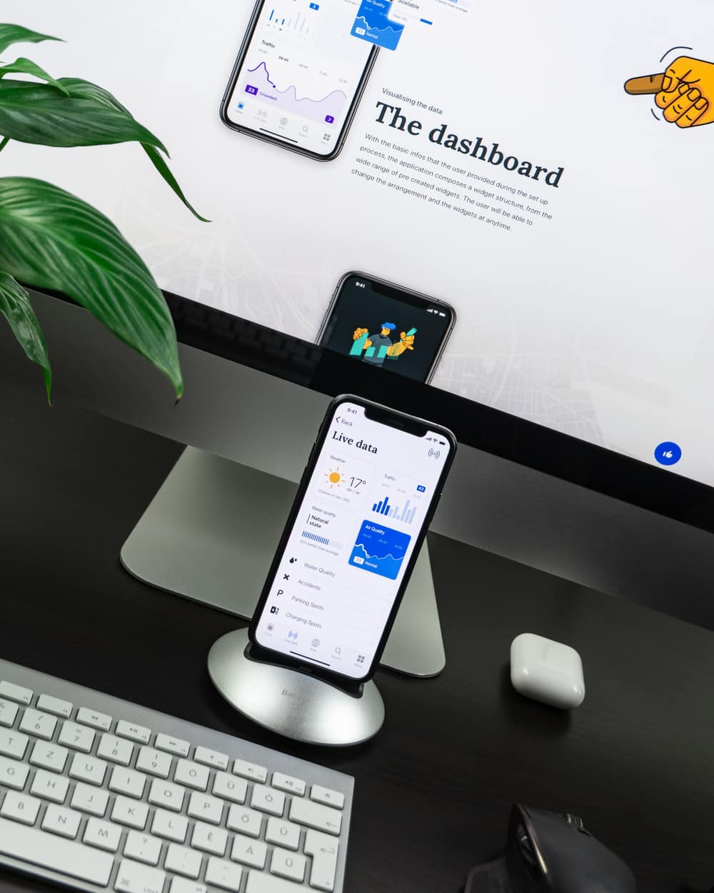 Mobile app interface design shown on a phone beside the design file on a desktop screen